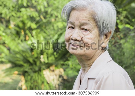 an old asian healthy woman is smiling