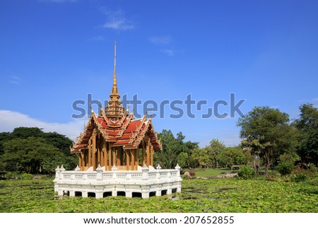Thai architecture pavilion in water lily flower pond on blue sky cloud in public park