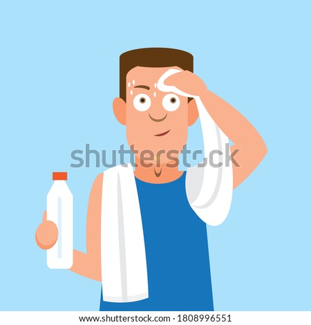 Man drying off with towel after sweating at gym while doing exercises or playing sport