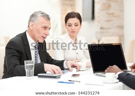 Senior CEO having staff meeting in restaurant