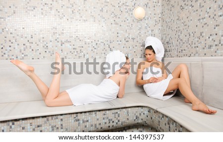 Two attractive girl friends in Turkish sauna