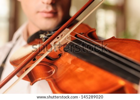 It sounds fascinating. Close up of men playing the violin