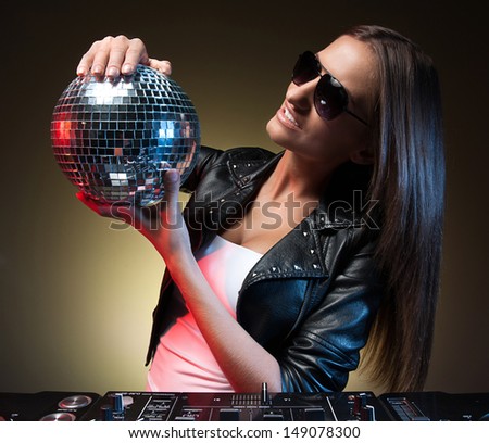 Women with disco ball. Beautiful young women holding disco ball and smiling