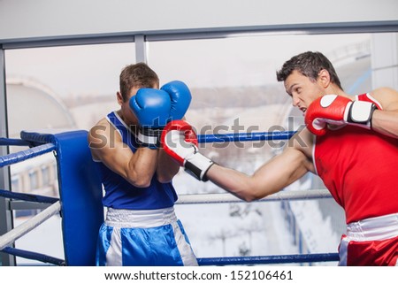 Men boxing. Two men boxing on the boxing ring