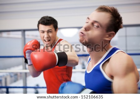 Men boxing. Two boxers fighting on the boxing ring