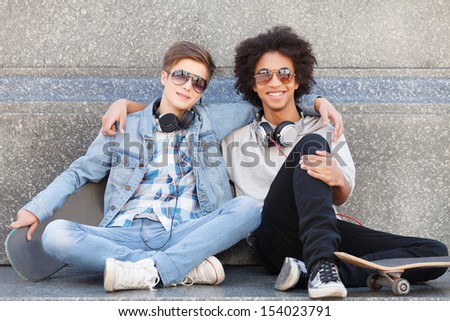 Teenage friends. Two cheerful teenage friends smiling at camera