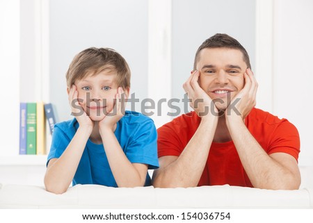 Cheerful father and son. Father and son looking at camera and smiling