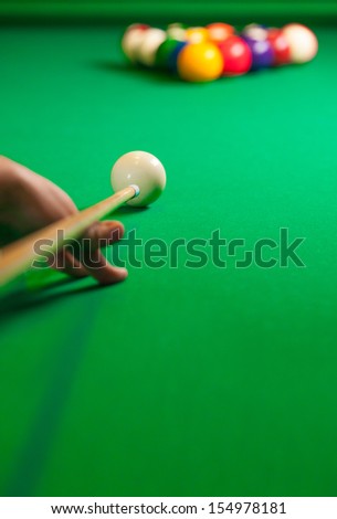 Billiards. Close-up of someone aiming the billiard ball with cue