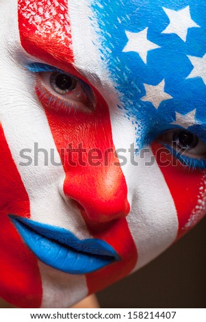 Close up of woman painted face. United States of America is painted on the face