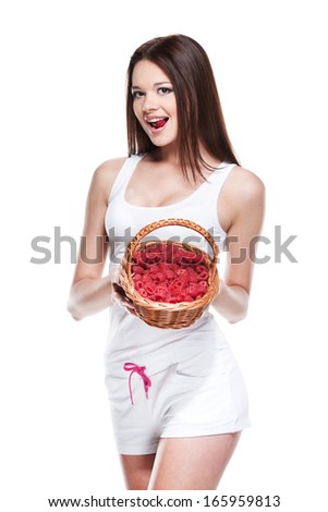 Sexy brunet girl in white clothes posing on camera. Holding fruit basket isolated over white background