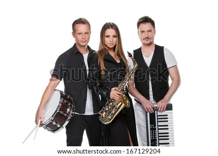 Sexy fashionable jazz band posing on camera. Standing with music instruments isolated over white background.