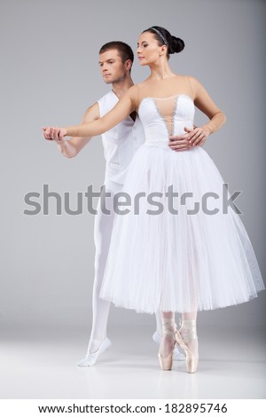 attractive dancing couple holding hands. beautiful ballet dancers tiptoe and looking