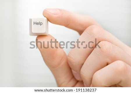 Help. Man\'s hand holding computer key on white background.