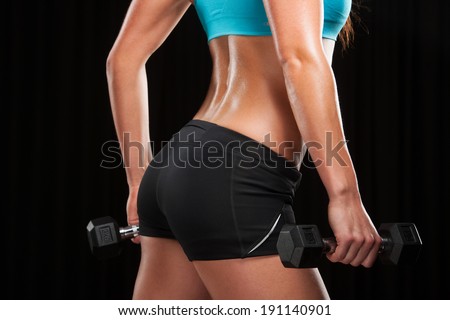 Sports woman. Woman lifting weights in a training session.
