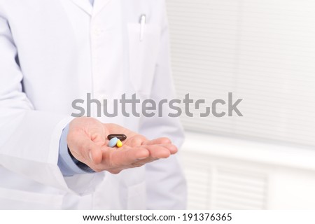 Hand with pills. Doctor giving pills to patient