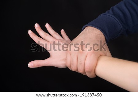 Holding Tight. Man holding female hand. Isolated