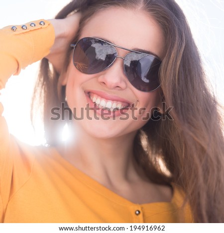Beautiful young girl wearing sunglasses. closeup woman portrait with long hair