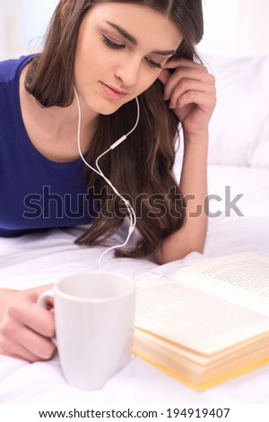 young attractive student girl reading. beautiful girl studying and listening music