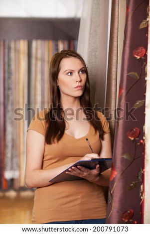 beautiful girl looking at tissue in store. attractive woman standing and writing data