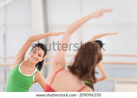 cropped image of fitness dance class doing aerobics. Women dancing happy energetic in gym fitness class.
