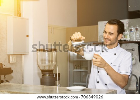 Young Barista Is Making Coffee In A Shop 706349026 Young Barista Is Making Coffee In A Shop 706349026
