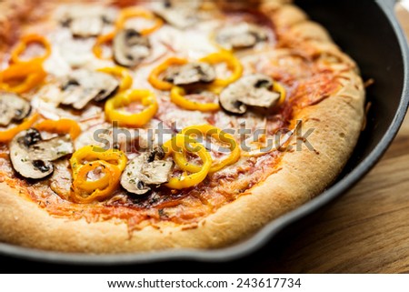 Pan pizza with mushrooms, pepperoni, onions, peppers and cheese.