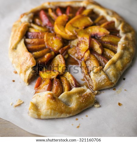 Peach and brown sugar galette on parchment paper.