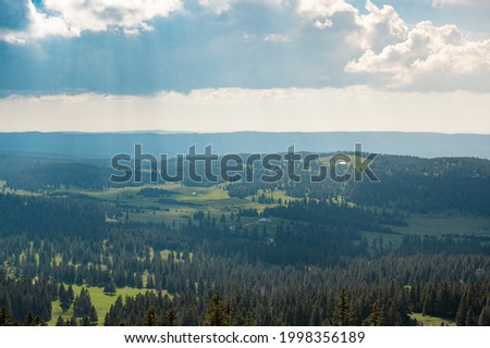 dramatic light over the hilly landscape of jura vaudoise near Col de Marchairuz Stockfoto © 