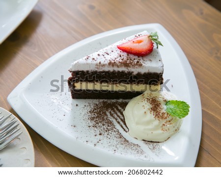 coffee ,a slice of cake on the plate on the background of cake