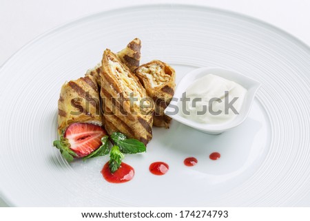 Wafer rolls filled with cream on the plate