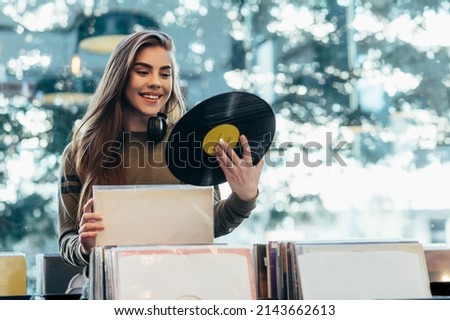 Similar – Image, Stock Photo Woman holding vinyl record. Music passion. Listening to music from analog record. Playing music from analog disk. Enjoying music from old collection. Retro and vintage. Stereo audio. Analog sound