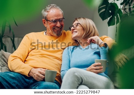 Similar – Image, Stock Photo Cheerful mature couple in stylish outfits in city