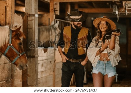 Image, Stock Photo A couple is horse riding on a meadow facing the distance. Romantic and active outdoor date. Autumn landscape, with young couple enjoying a horse riding. Overcast weather, beautiful horses.