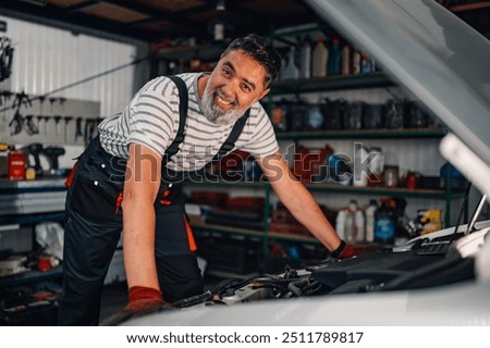 Similar – Image, Stock Photo Aged repairman in professional workshop with tools