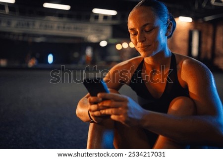 Similar – Image, Stock Photo Sportswoman using smartphone after training