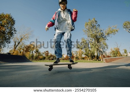 Similar – Image, Stock Photo Skater performing trick on ramp in skate park