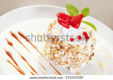 Kiev cake with nuts, strawberry and min twig