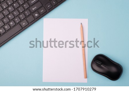 Working near computer concept. Top above close up overhead view photo of sheet of paper computer keyboard and wireless mouth isolated over blue desk background with copy empty blank space 商業照片 © 