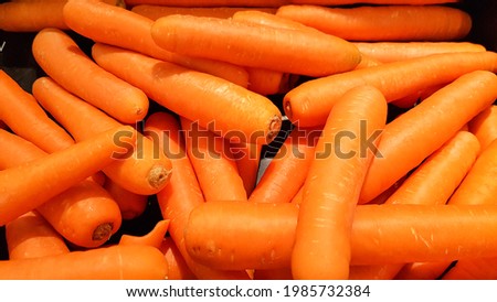 Carrots placed in a stall for sale.Macro Photo spring food vegetable carrot. Texture background of fresh large orange carrots. Product Image Vegetable Root Carrot.