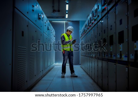 The engineer checking and inspecting at MDB panel .he working with electric switchboard to check range of voltage working in Main Distribution Boards factory. Stock foto © 