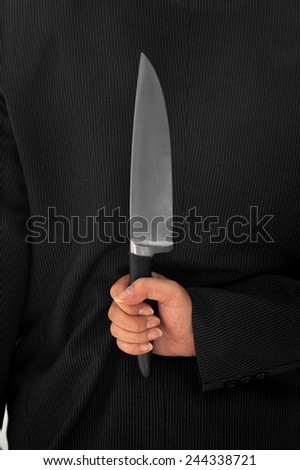 Closeup Businessman Holding Knife Behind His Back conceptual image Isolated