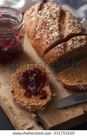 Dark multigrain bread fresh baked rustic breakfast food Whole grain homemade bakery tasty fruit jam berry