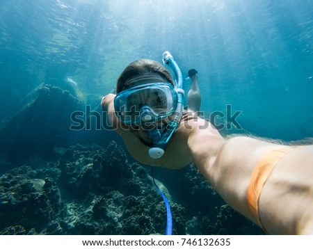 Similar – Image, Stock Photo Young man with snorkel and diving mask swimming and taking a selfie under water. Travel, vacation and sports activity concept.