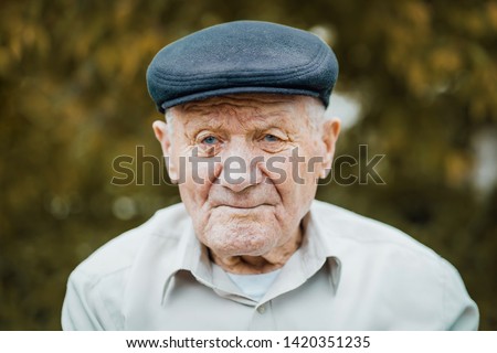 Similar – Image, Stock Photo Portrait of very old farmer with straw hat explaining life in front of a red tractor.