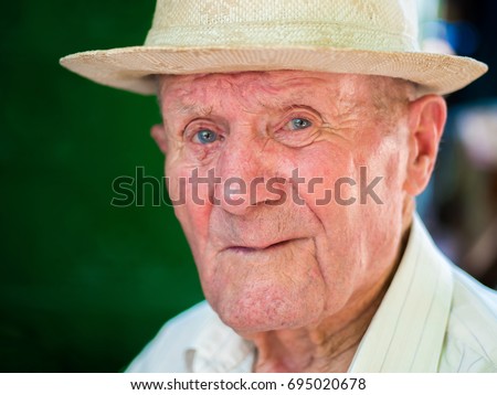 Similar – Image, Stock Photo Portrait of very old farmer with straw hat explaining life in front of a red tractor.