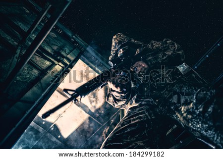 Soldier with rifle aiming at target ready to shoot