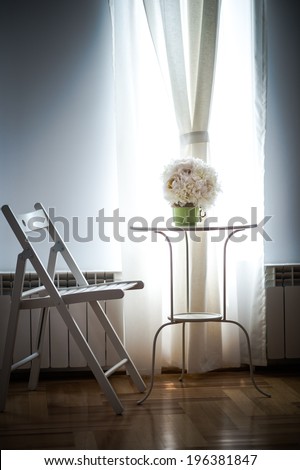 Beautiful white wedding bouquet near sunny window