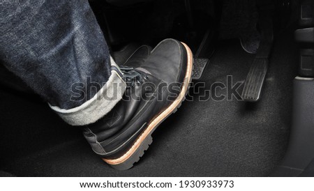 Accelerator and breaking pedal in a car. Close up the foot pressing foot pedal of a car to drive ahead. Driver driving the car by pushing accelerator pedals of the car. inside vehicle.  Foto d'archivio © 