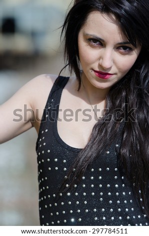 Young woman in black shirt with weaving long hair and different eye color eyes