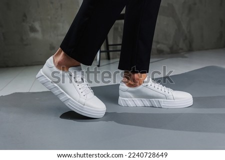 Similar – Image, Stock Photo Black pants, sneakers, legs stand with shadow on pavement